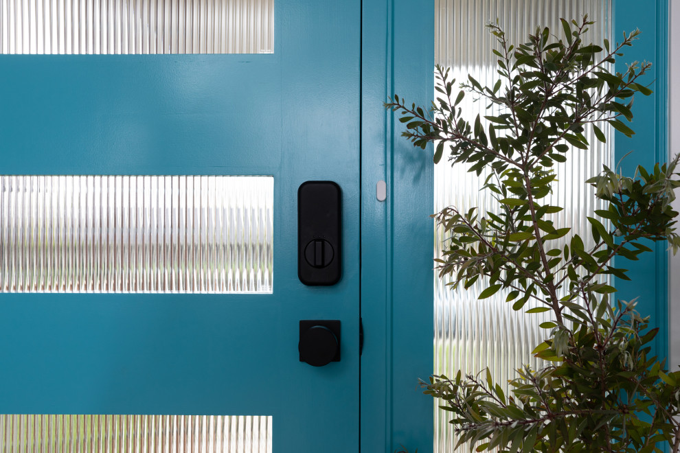 Design ideas for a midcentury front door in Los Angeles with a glass front door.