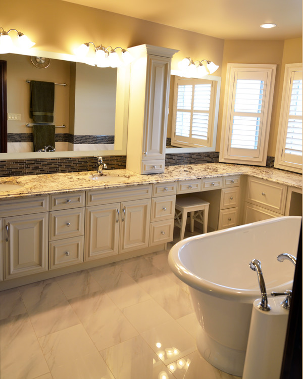 Freestanding bathtub - large transitional master white tile porcelain tile freestanding bathtub idea in Calgary with an undermount sink, white cabinets, granite countertops, beaded inset cabinets and beige walls