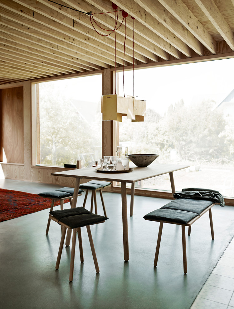 Large scandinavian open plan dining in Other with brown walls, concrete floors, grey floor and no fireplace.