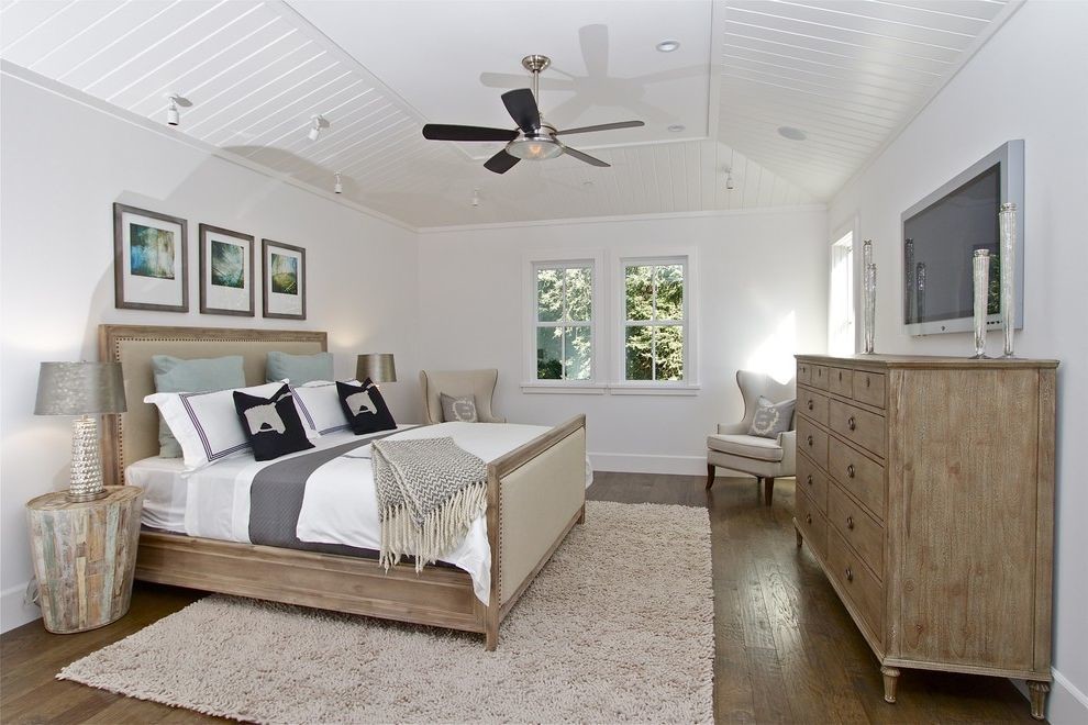 Mid-sized country master bedroom in San Francisco with white walls, medium hardwood floors and brown floor.