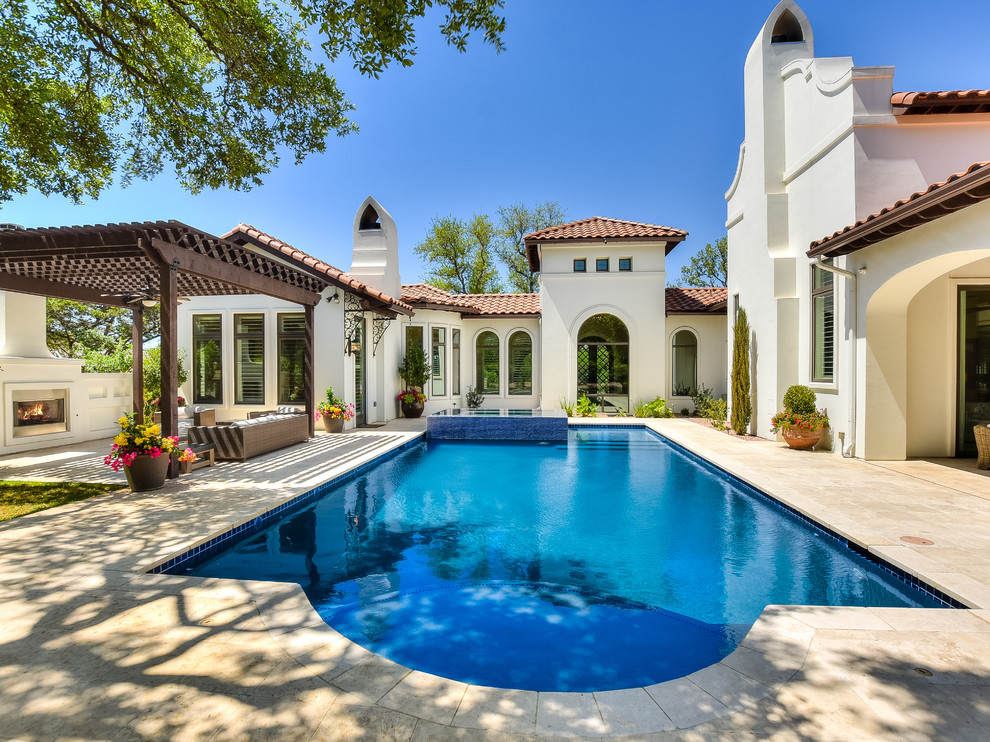 Large transitional backyard stone and rectangular lap pool photo in Austin