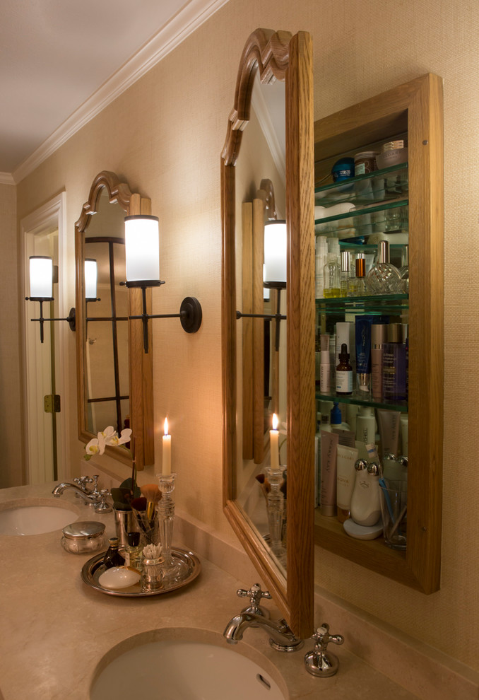 This is an example of a mid-sized mediterranean master bathroom in Dallas with furniture-like cabinets, distressed cabinets, a freestanding tub, an alcove shower, a two-piece toilet, beige tile, travertine, beige walls, travertine floors, an undermount sink, marble benchtops, beige floor and a hinged shower door.