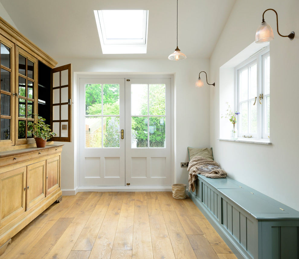Design ideas for a mid-sized country mudroom in Los Angeles with white walls, light hardwood floors, a double front door, a white front door and yellow floor.
