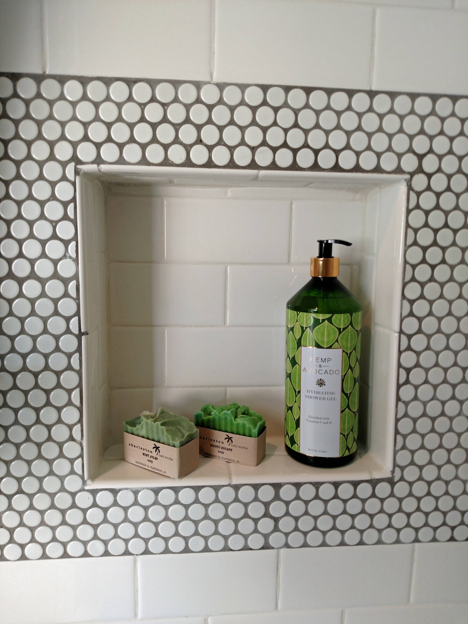 Subway tile with Penny tile accents and floor in a family bathroom.