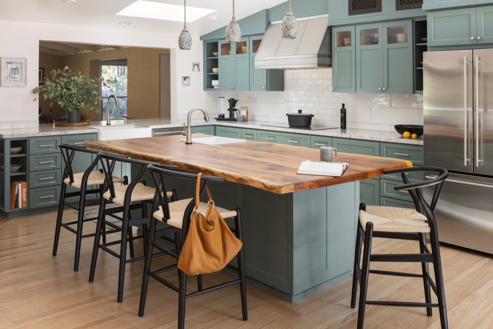 Design ideas for a large transitional kitchen in San Francisco with a single-bowl sink, shaker cabinets, green cabinets, wood benchtops, white splashback, subway tile splashback, stainless steel appliances, medium hardwood floors and with island.