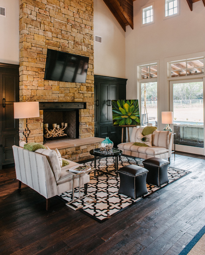 Photo of a transitional living room in Austin with dark hardwood floors, a standard fireplace and a wall-mounted tv.
