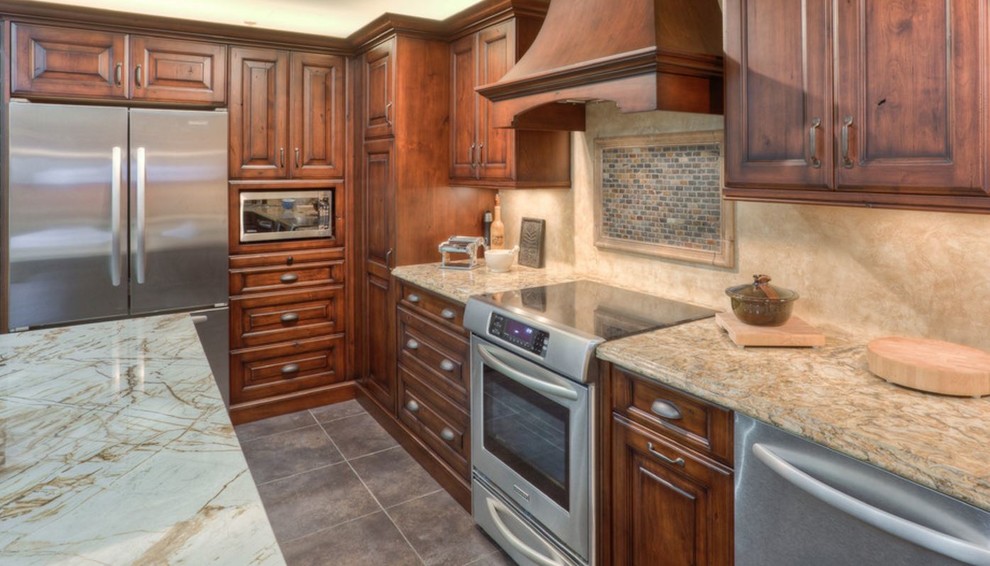 Large mountain style u-shaped porcelain tile eat-in kitchen photo in Toronto with an undermount sink, raised-panel cabinets, brown cabinets, quartz countertops, beige backsplash, stainless steel appliances and an island