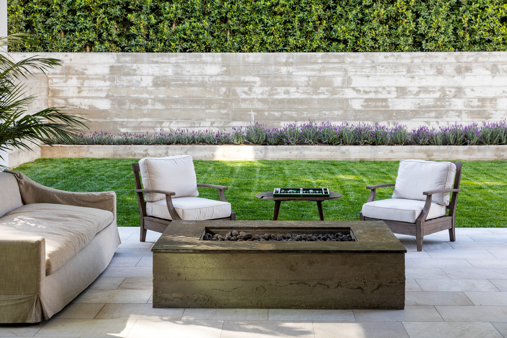 Transitional backyard patio in Los Angeles with a fire feature, tile and no cover.