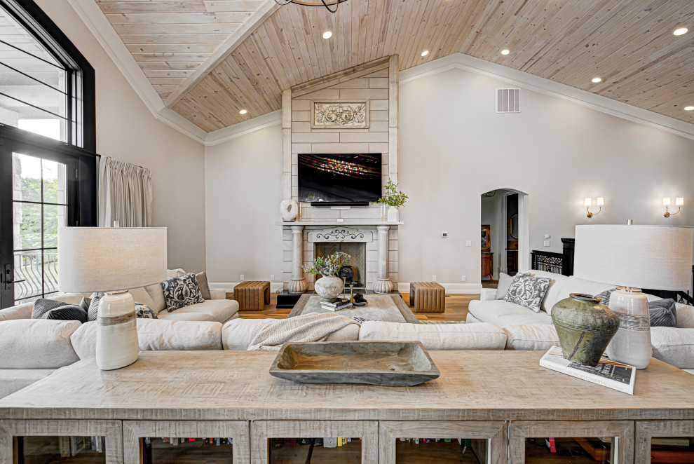 Inspiration for a medium sized contemporary living room in Indianapolis with medium hardwood flooring, a standard fireplace, a wall mounted tv, a wood ceiling, white walls, a tiled fireplace surround and brown floors.