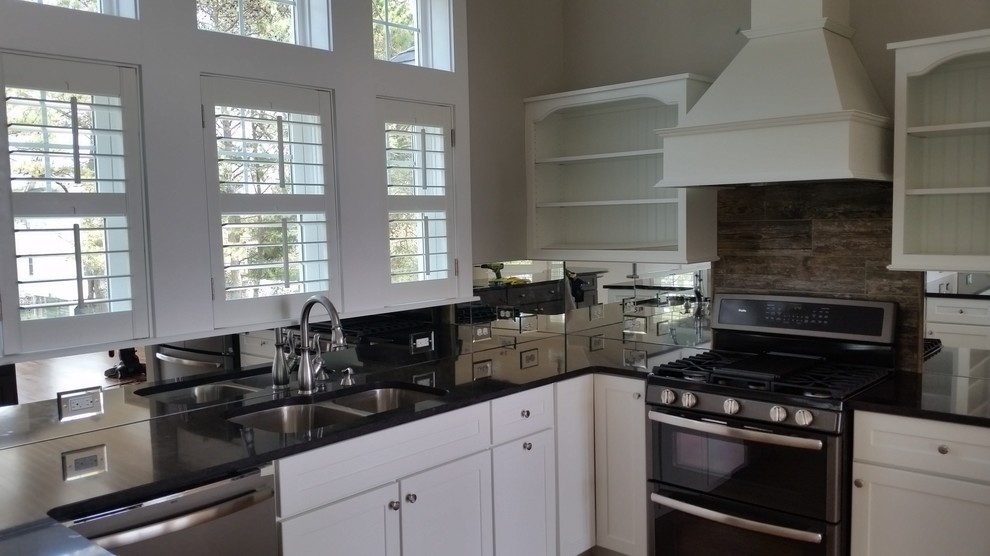 Kitchen - transitional kitchen idea with a double-bowl sink, open cabinets, white cabinets, quartz countertops, metallic backsplash, mirror backsplash, stainless steel appliances and an island