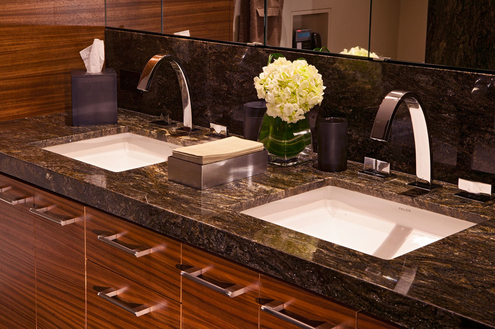 Inspiration for a mid-sized contemporary bathroom in Denver with an undermount sink, flat-panel cabinets, medium wood cabinets, granite benchtops, black tile, stone slab, a built-in vanity, wood walls, black benchtops and a double vanity.