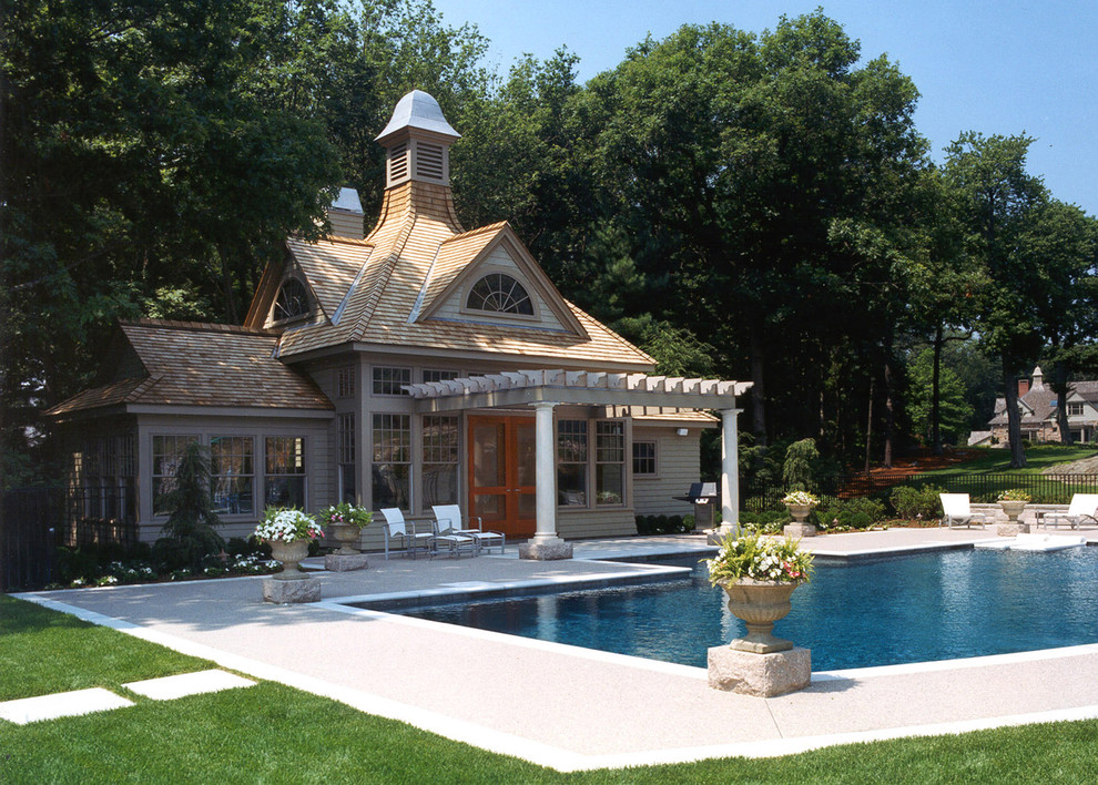 Inspiration for a traditional rectangular pool in Boston with a pool house.