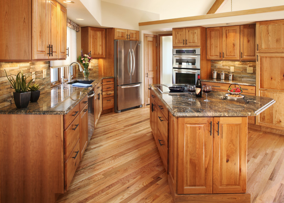 Example of a large mountain style light wood floor kitchen design in Denver with a single-bowl sink, recessed-panel cabinets, light wood cabinets, multicolored backsplash, stainless steel appliances, an island and stone tile backsplash