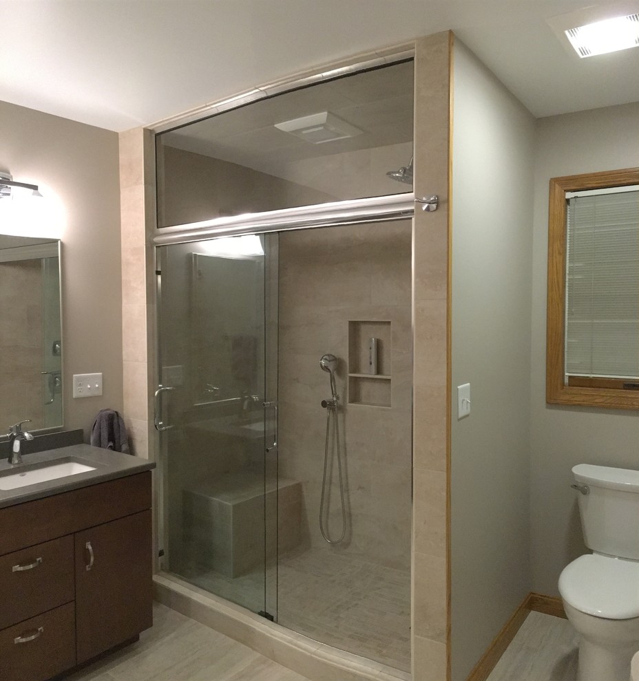 Large transitional master beige tile and porcelain tile porcelain tile alcove shower photo with flat-panel cabinets, dark wood cabinets, a two-piece toilet, green walls, an undermount sink and quartz countertops