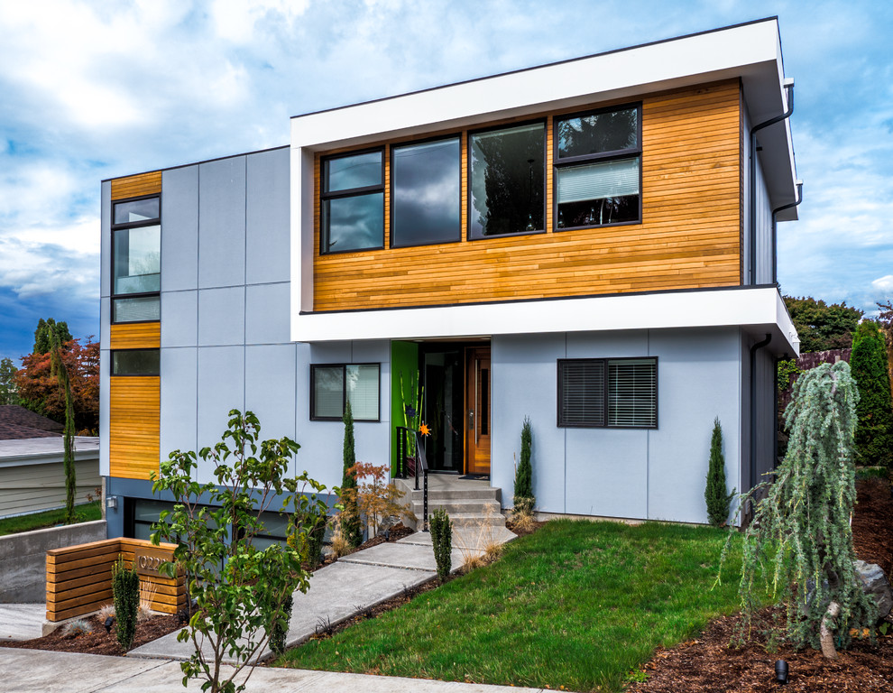 Design ideas for a mid-sized contemporary two-storey exterior in Seattle with concrete fiberboard siding.