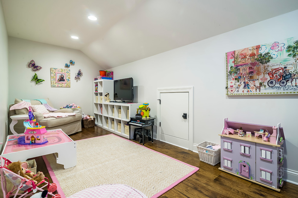 This is an example of a mid-sized contemporary kids' playroom for kids 4-10 years old and girls in Chicago with white walls and dark hardwood floors.