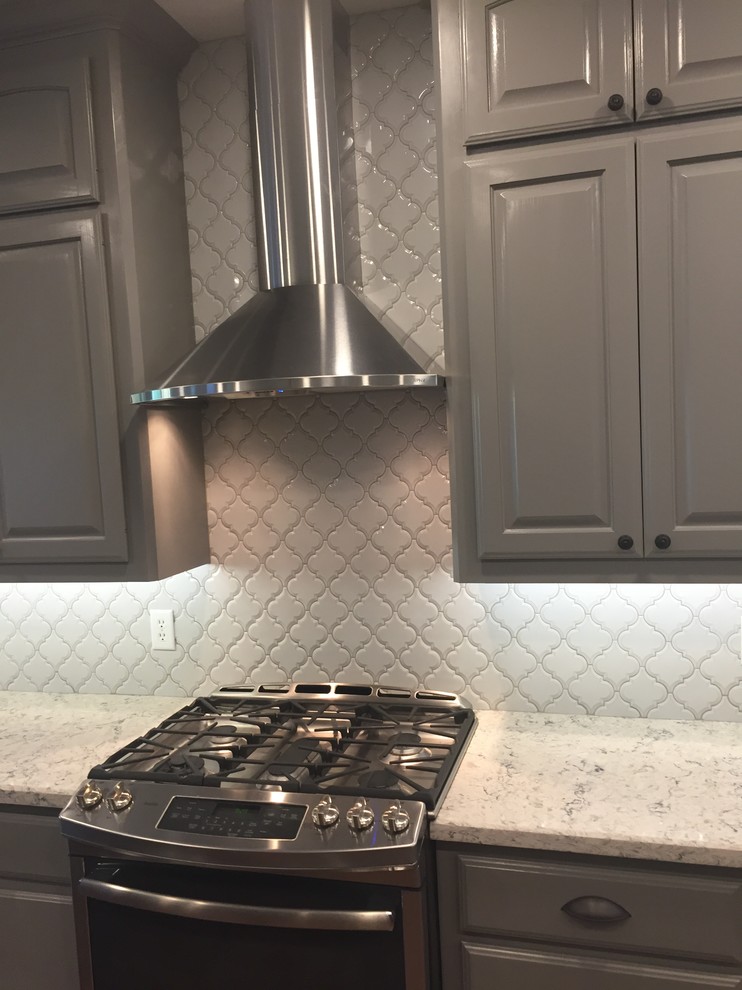 Transitional eat-in kitchen photo in Austin with gray backsplash and porcelain backsplash