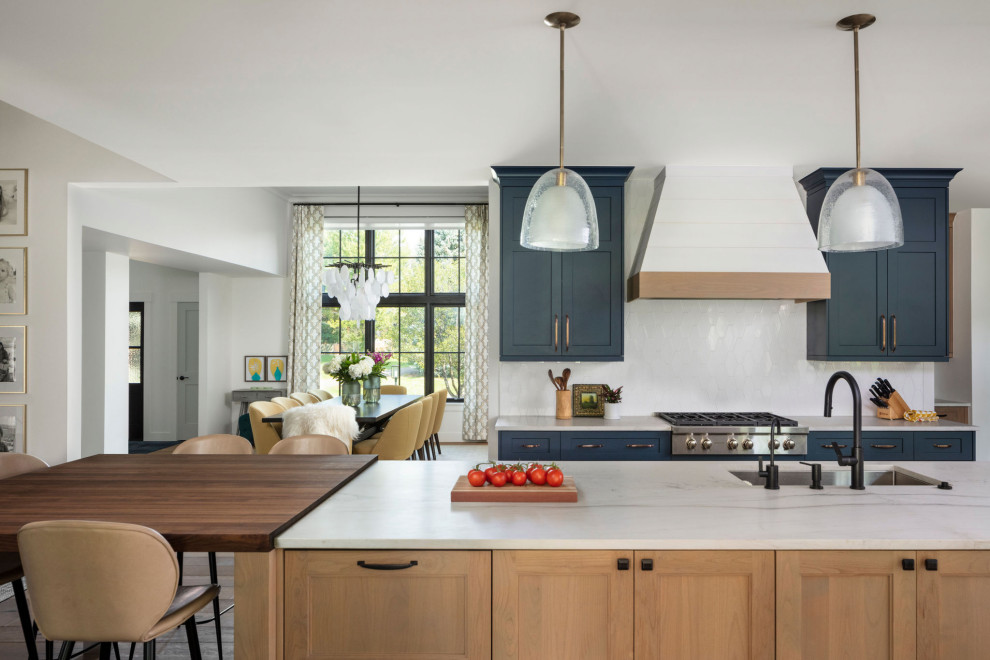 Example of a mid-sized transitional l-shaped medium tone wood floor and beige floor eat-in kitchen design in Denver with an undermount sink, shaker cabinets, blue cabinets, quartzite countertops, white backsplash, ceramic backsplash, paneled appliances, an island and white countertops