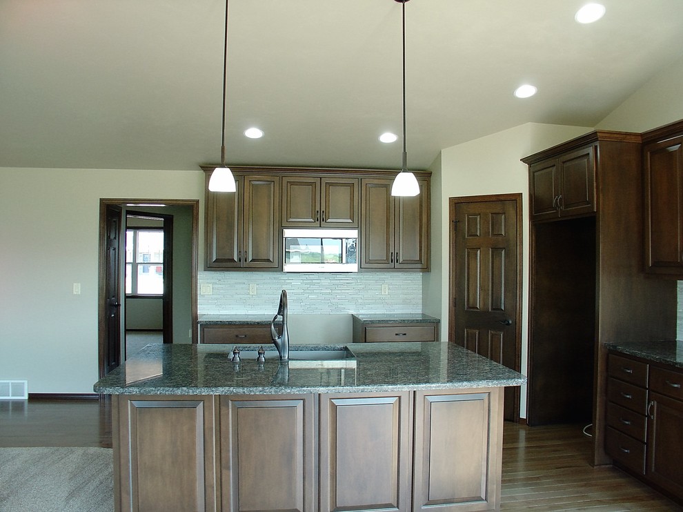 Open concept kitchen - large light wood floor open concept kitchen idea with an island