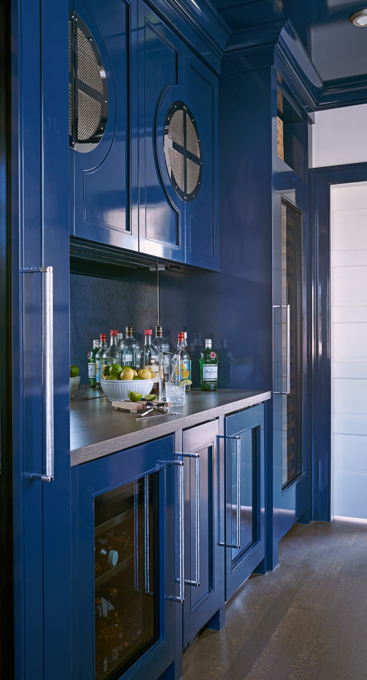 Inspiration for a mid-sized beach style single-wall wet bar in New York with a drop-in sink, recessed-panel cabinets, blue cabinets, wood benchtops, multi-coloured splashback, metal splashback, dark hardwood floors, brown floor and brown benchtop.