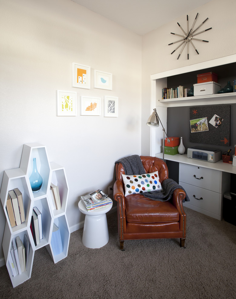 This is an example of a mid-sized contemporary home office in San Francisco with white walls, carpet, no fireplace, a built-in desk and grey floor.