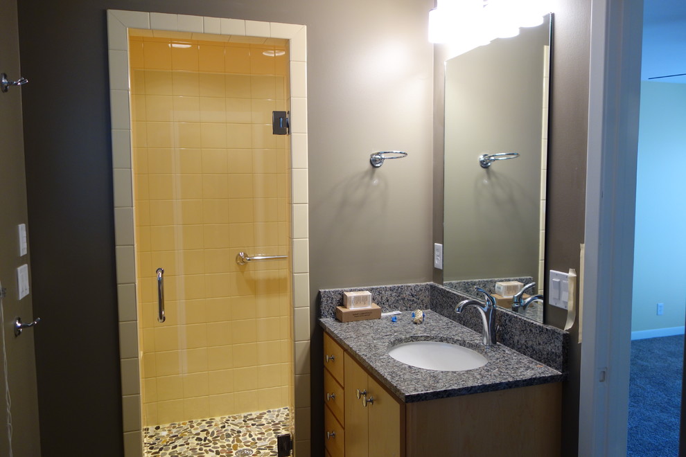 Inspiration for a small modern master bathroom in Other with an undermount sink, flat-panel cabinets, light wood cabinets, granite benchtops, an alcove shower, a two-piece toilet, yellow tile, porcelain tile, brown walls and linoleum floors.