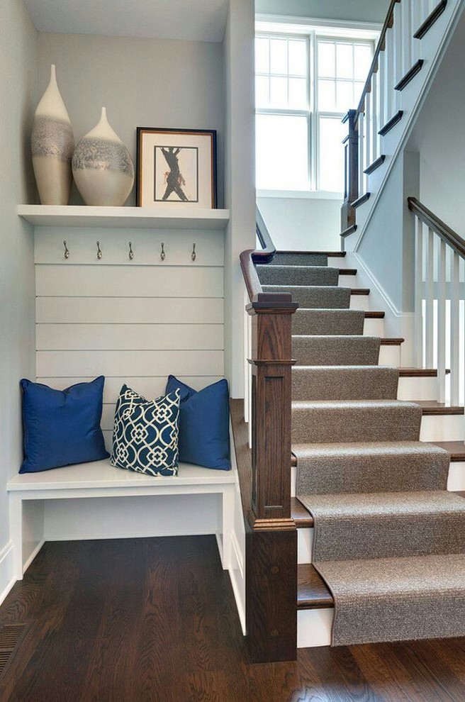 Photo of a mid-sized traditional wood u-shaped staircase in Other with wood railing and painted wood risers.