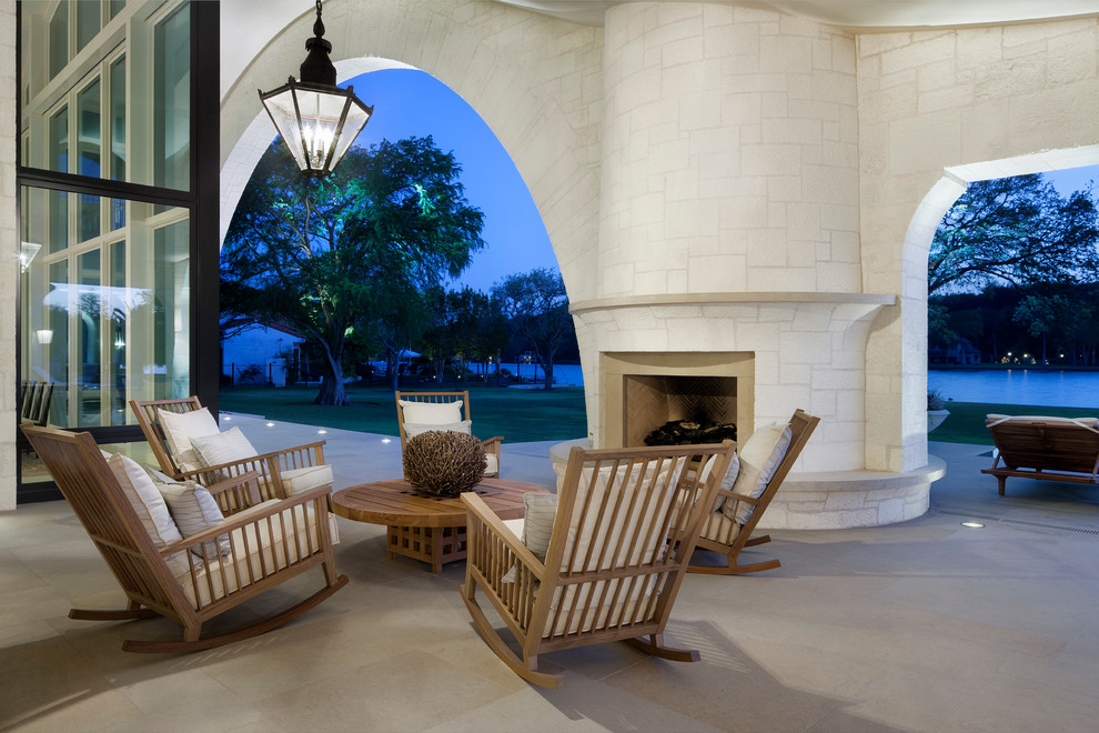 Inspiration for a mediterranean patio in Austin with a roof extension and with fireplace.