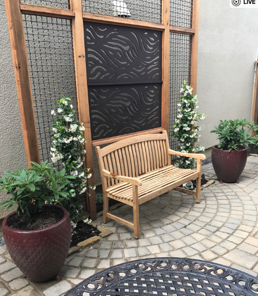This is an example of a small transitional courtyard concrete paver formal garden.