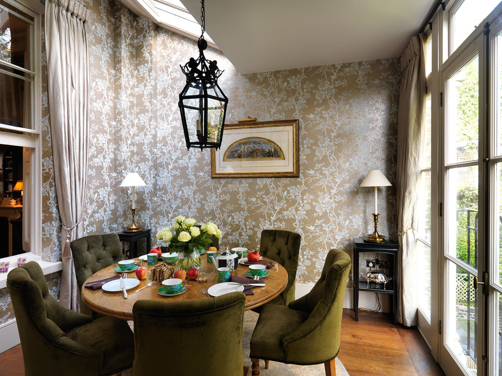 Inspiration for a traditional separate dining room in London with medium hardwood floors.