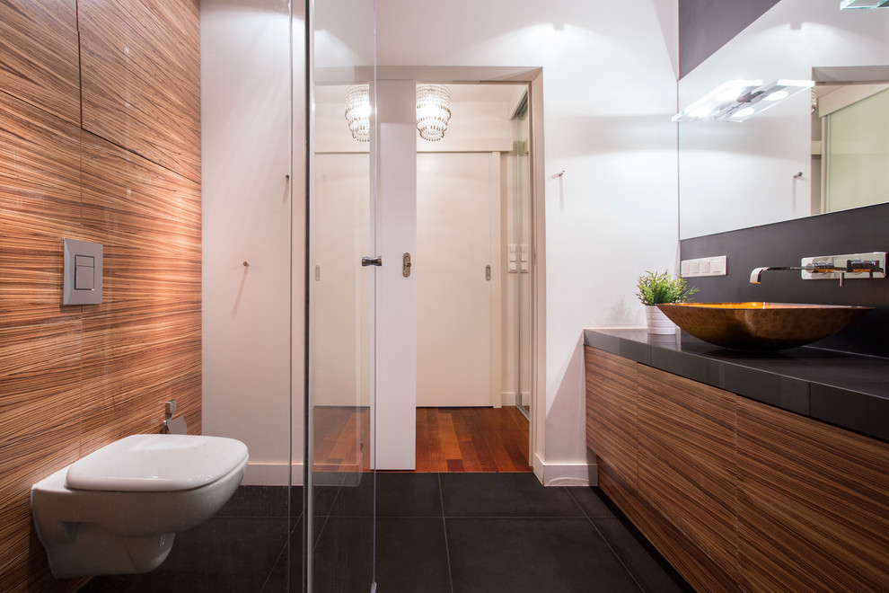 Photo of a small asian master bathroom in Los Angeles with furniture-like cabinets, dark wood cabinets, a corner tub, a curbless shower, a one-piece toilet, white tile, cement tile, white walls, ceramic floors, a vessel sink, granite benchtops, black floor and a sliding shower screen.