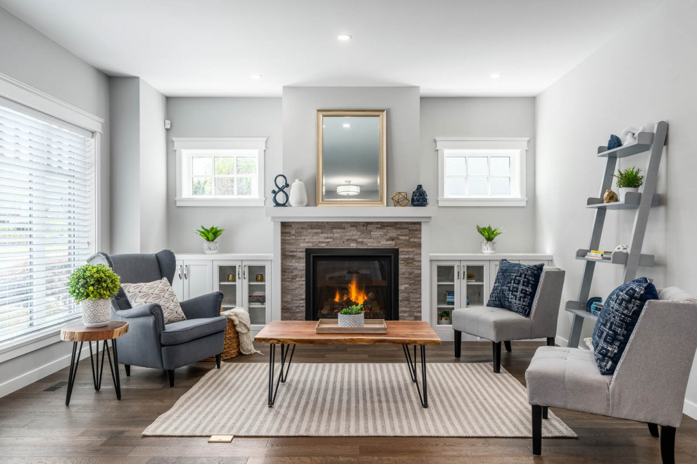Mid-sized transitional open concept living room in Vancouver with grey walls, medium hardwood floors, a standard fireplace, a brick fireplace surround and brown floor.