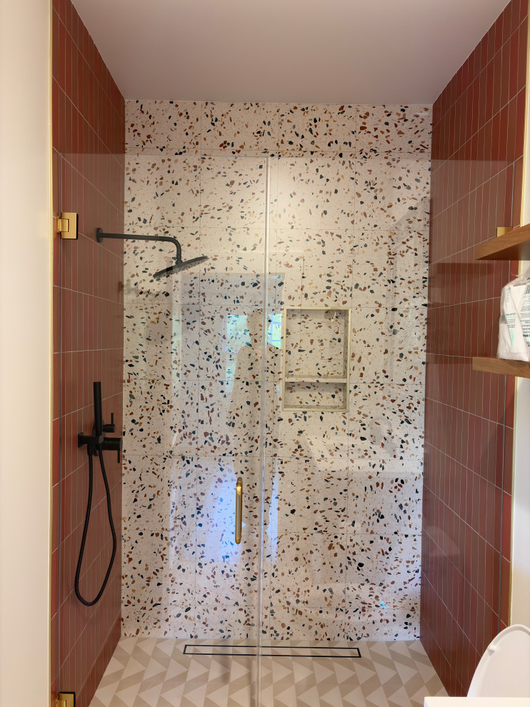 Terrazzo-Look Walk-In Shower with Terracotta Tile and Black Fixtures