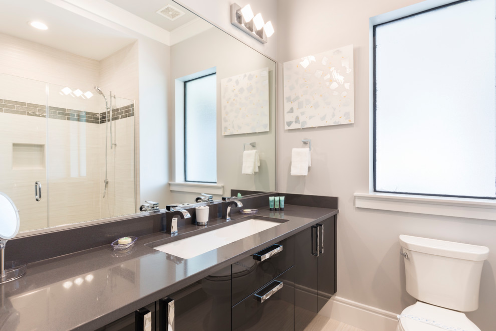 Bathroom - large modern master black and white tile and porcelain tile porcelain tile and white floor bathroom idea in Orlando with flat-panel cabinets, brown cabinets, a two-piece toilet, white walls, an undermount sink and quartz countertops
