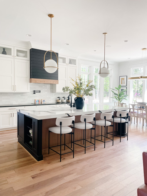 Bright modern kitchen with white uppers, dark island, and wood floors—hero image for RTA cabinets maintenance in Canada, showcasing a clean, organized space