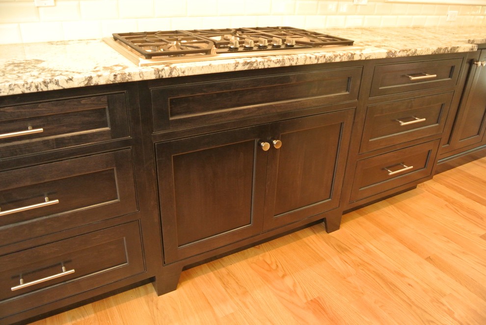 Transitional light wood floor eat-in kitchen photo in Boston with an undermount sink, shaker cabinets, granite countertops, white backsplash, subway tile backsplash, stainless steel appliances and an island
