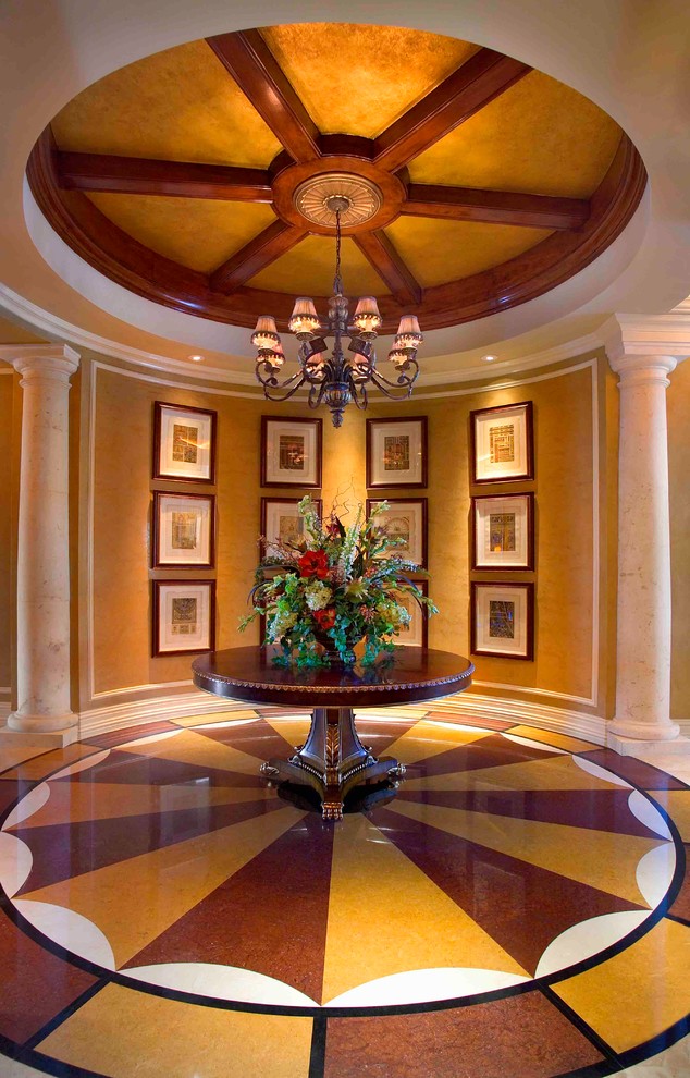 This is an example of a mediterranean foyer in Other with yellow walls, multi-coloured floor and marble floors.