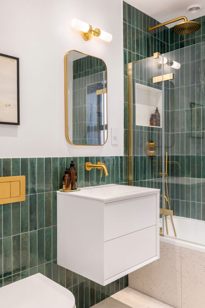 This is an example of a medium sized traditional bathroom in Hampshire with flat-panel cabinets, white cabinets, a built-in bath, a shower/bath combination, a one-piece toilet, matchstick tiles, green walls, a wall-mounted sink, an open shower, a single sink and a floating vanity unit.