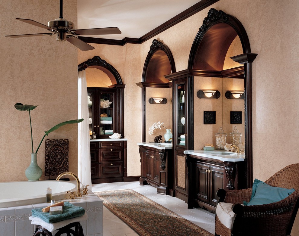 Large eclectic master bathroom in Houston with raised-panel cabinets, dark wood cabinets, a corner tub, white tile, ceramic tile, multi-coloured walls, marble floors, an undermount sink and engineered quartz benchtops.
