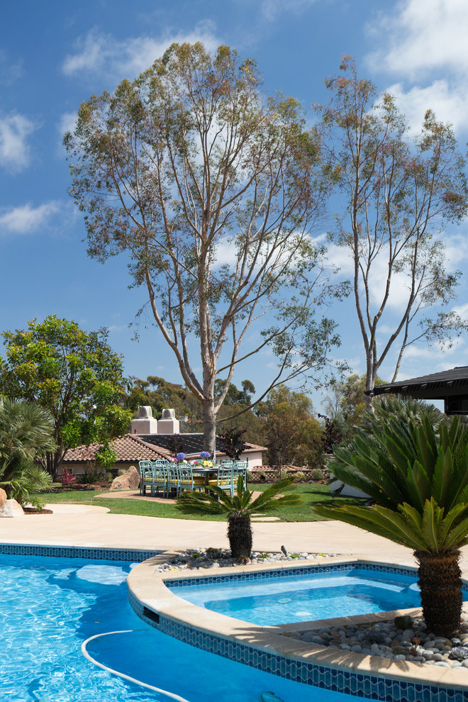 Hot tub - large transitional backyard concrete paver and custom-shaped hot tub idea in Los Angeles