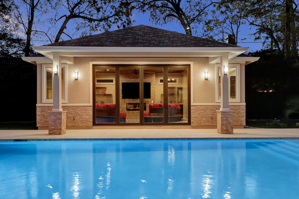 This is an example of a medium sized traditional back patio in Houston with a fireplace and natural stone paving.