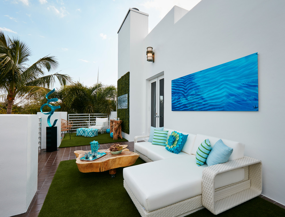 Inspiration for a large contemporary backyard patio in Miami with decking and no cover.