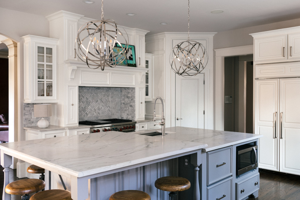Eat-in kitchen - large transitional u-shaped medium tone wood floor and brown floor eat-in kitchen idea in Atlanta with an undermount sink, raised-panel cabinets, white cabinets, marble countertops, white backsplash, marble backsplash, stainless steel appliances and an island