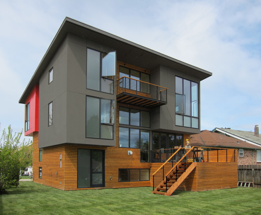 Design ideas for a modern exterior in Seattle with wood siding and a shed roof.