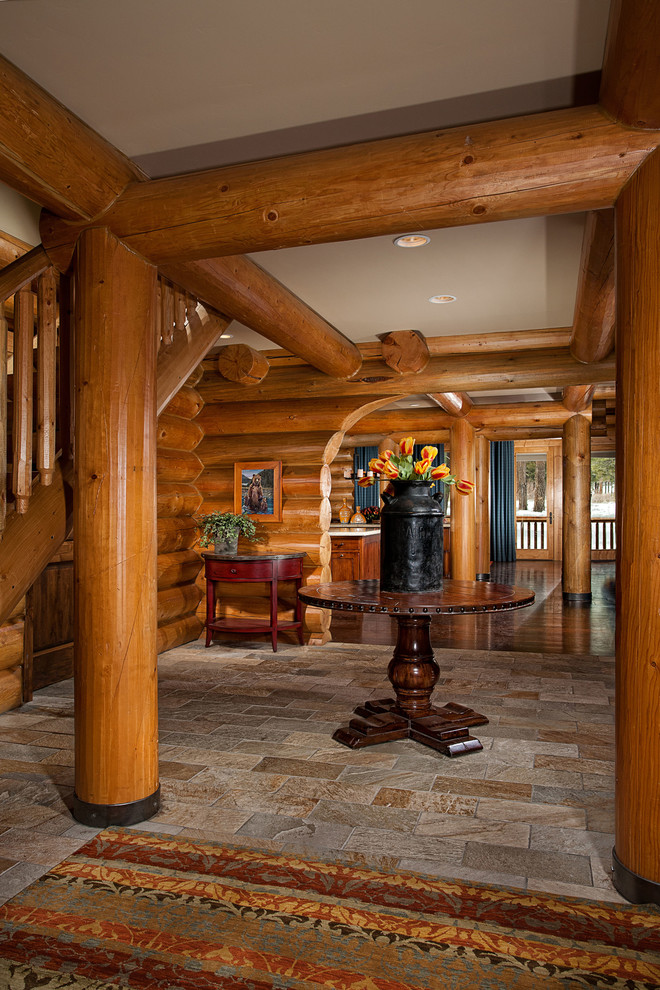 Photo of a mid-sized traditional foyer in Other with slate floors and brown walls.