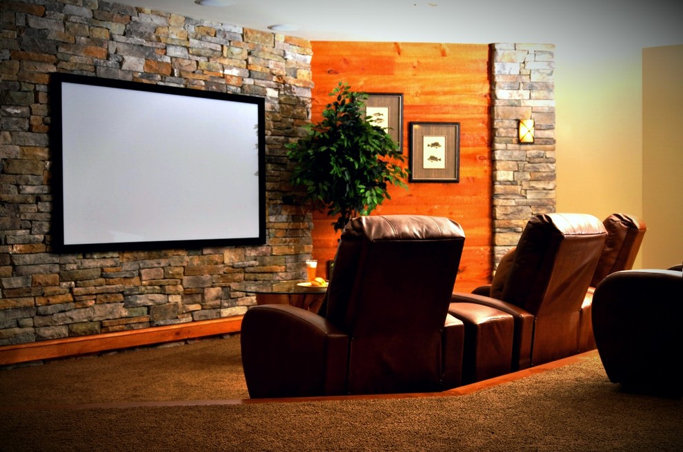 This is an example of an expansive traditional home theatre in Philadelphia with green walls, carpet and beige floor.