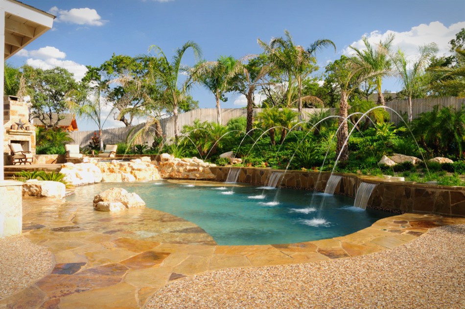 Inspiration for a large rustic backyard stone and custom-shaped natural pool remodel in Austin