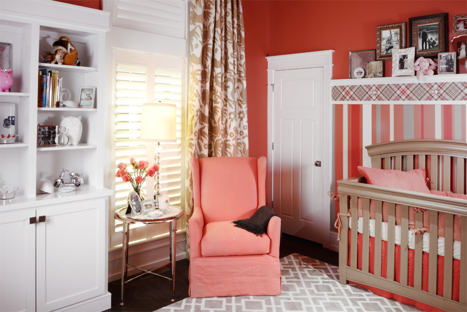 This is an example of a mid-sized traditional nursery for girls in Other with orange walls and medium hardwood floors.