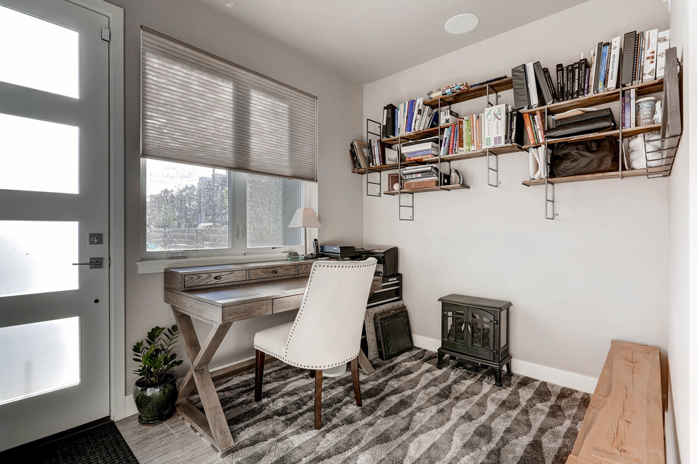 Inspiration for a mid-sized modern study room in Denver with grey walls, a freestanding desk, porcelain floors and grey floor.