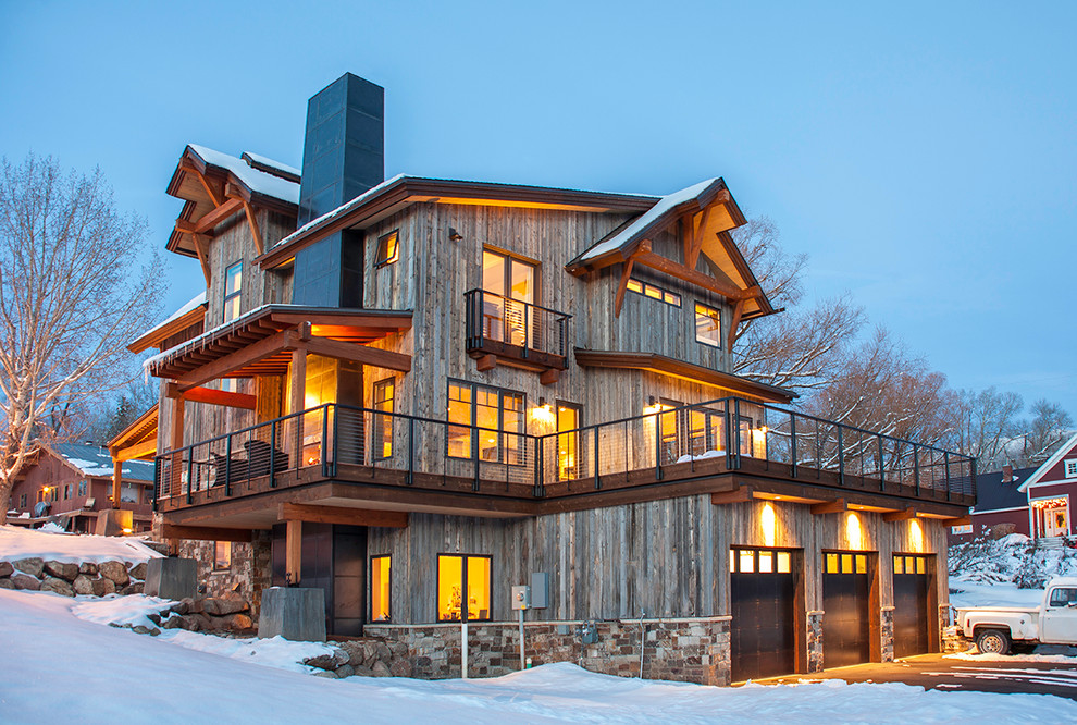Inspiration for a mid-sized country three-storey exterior in Denver with wood siding.